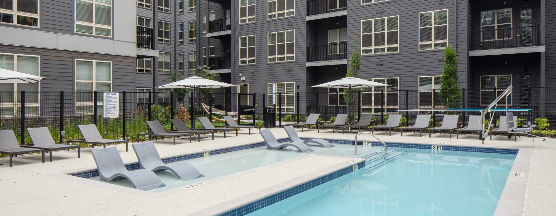 a building with a pool and seating