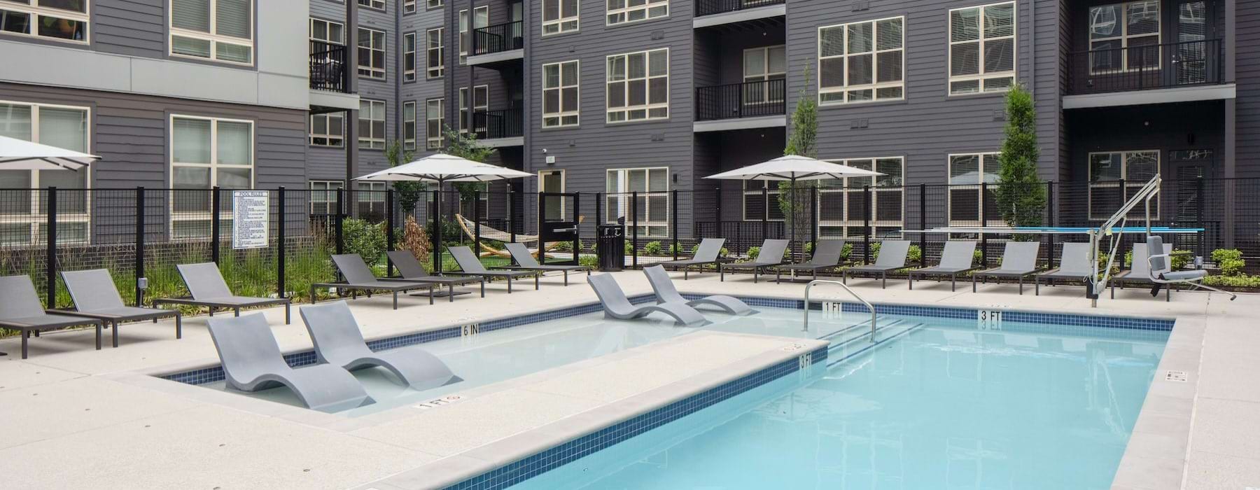 a building with a pool and seating
