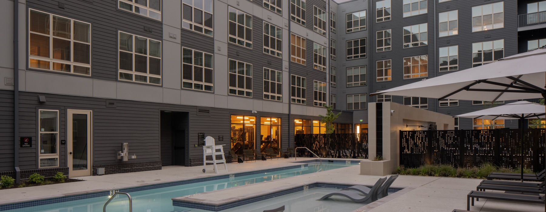 a pool in a courtyard with buildings around it