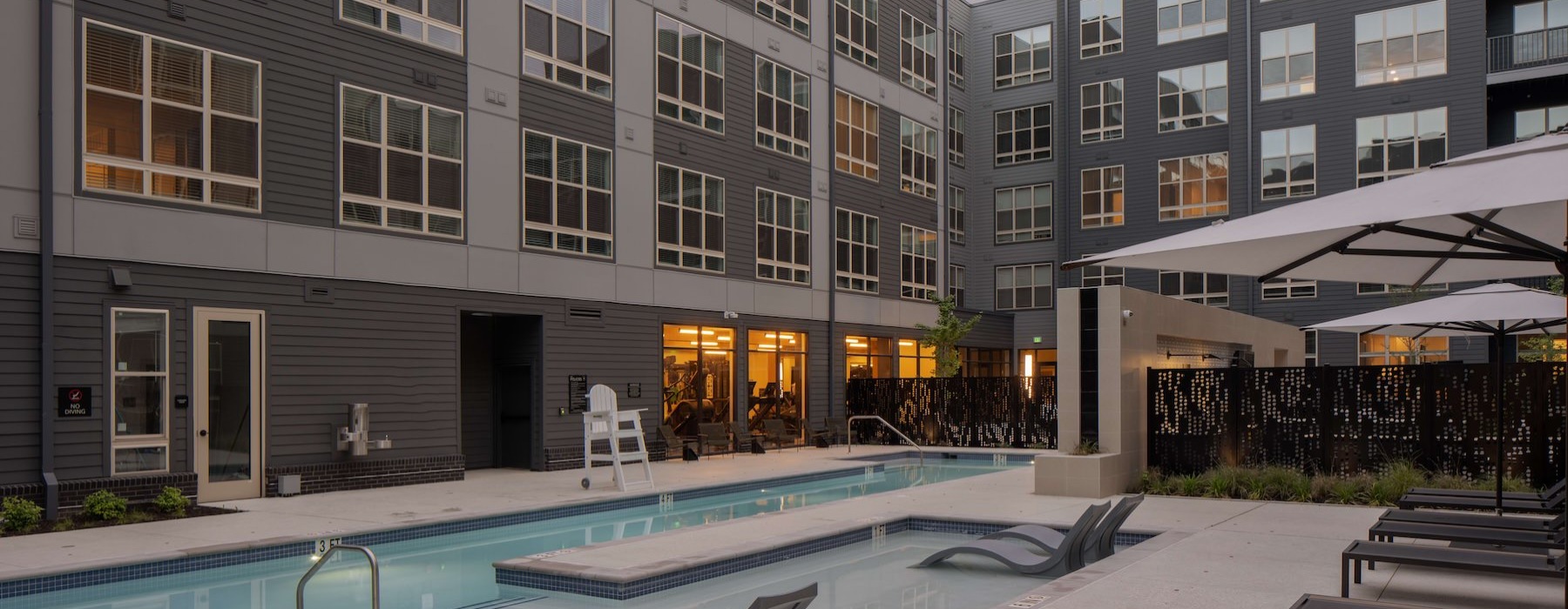 a pool in a courtyard with buildings around it