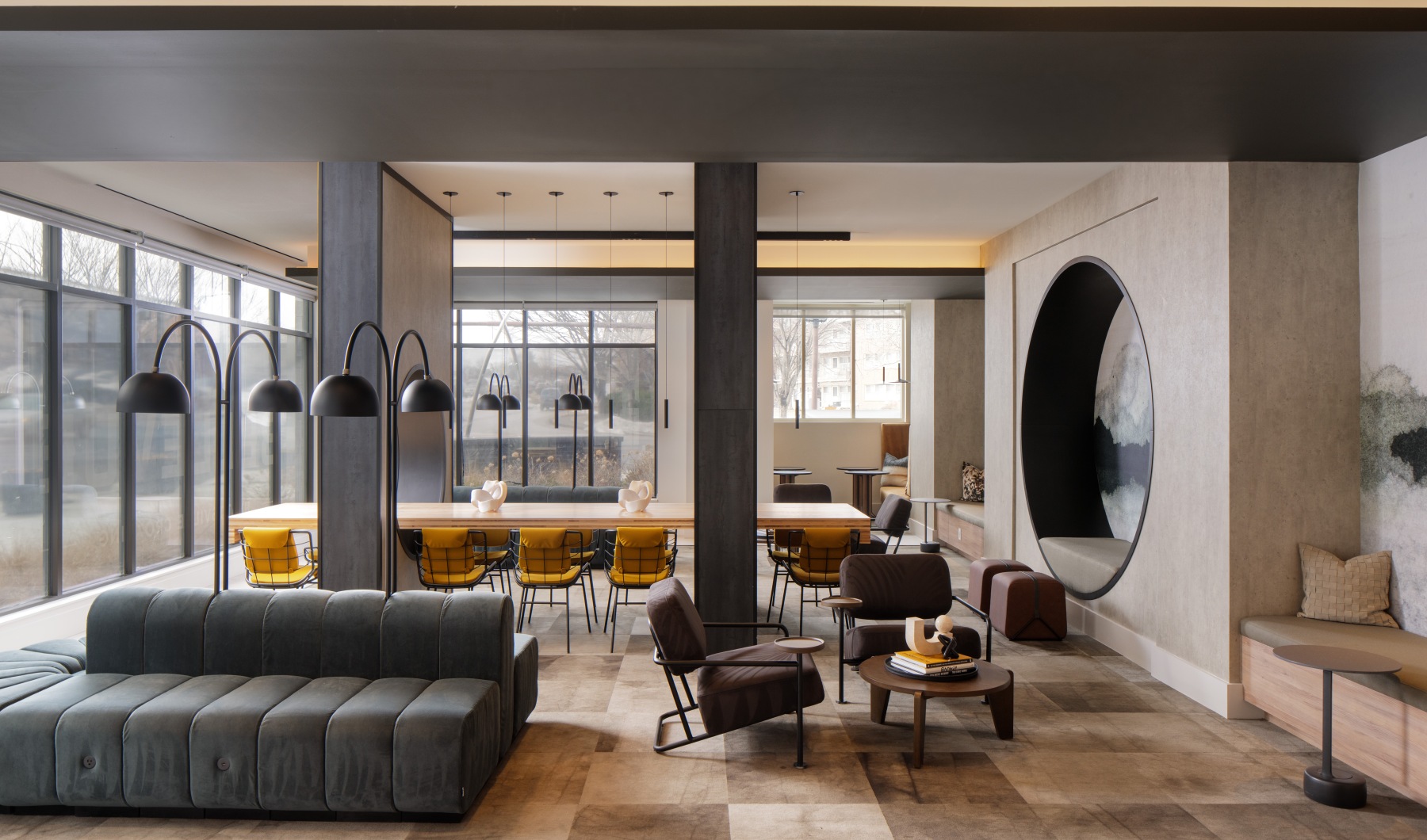 Large well lit room with different seating options including tables booths and couches 