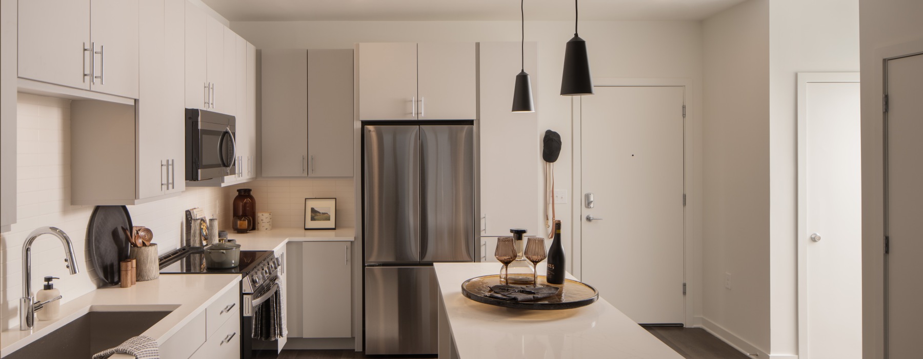 kitchen with flat panel cabinets and pendant lights with stainless steel appliances