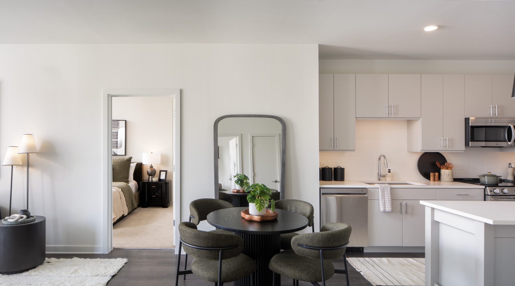 living room dining room and kitchen with door to bedroom 