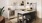 a kitchen with a table and a refrigerator