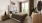 a bedroom with a bed and a mirror