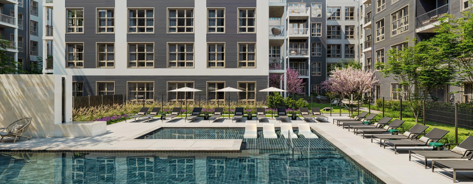 a pool in a courtyard with buildings around it